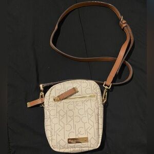 Calvin klein bag, it’s white with brown straps.